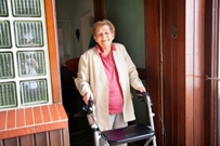 Woman at door with walking frame